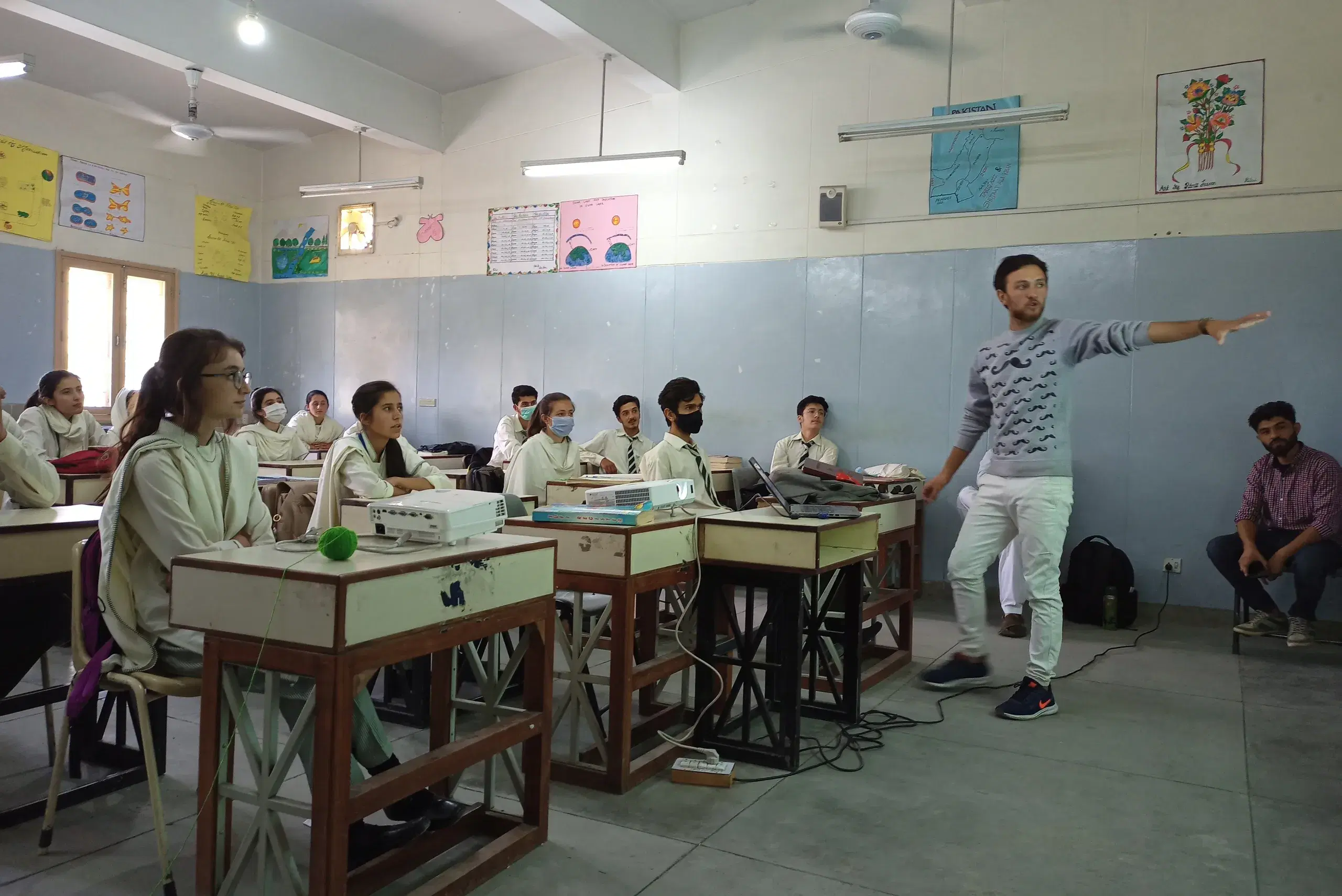 A young man presenting to a classroom of school students in northern Pakistan.