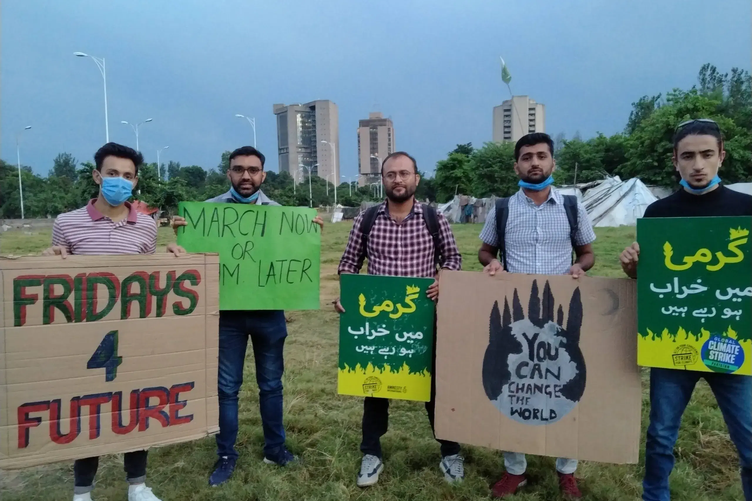 Young climate campaigners holding Fridays for Future placards.